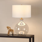 Hudson&Canal Laelia 24.75" Tall Table Lamp with Fabric Shade - Clear Glass/Brass/White-Rated for one 60W incandescent bulb - 9W LED bulb, 13W fluorescent (CFL) bulb, or 9W self-ballasted LED bulb, E26-base bulb, Bulb not included