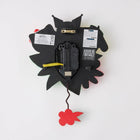 Enesco Allen Designs Sanrio Hello Kitty and Friends Pendulum Wall Clock-Features Hello Kitty, Pompompurin, and Kuromi peeking out from behind a stunning array of colourful flowers, with a vibran red flower pendulum