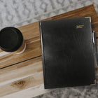 Brownline 2027 Executive Appointment Book Daily Planner with Sewn Binding - 10-3/4" x 7-3/4" - Black - Trilingual-Shaded priority and notes boxes on
each spread
