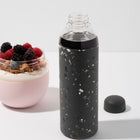 W&P Porter Glass Water Bottle - Terrazzo Charcoal-Constructed from durable, lightweight glass with a grippable silicone sleeve & twist-off cap