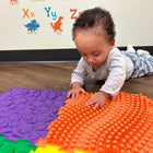 Kore Design Locking Sensory Tactile Tiles - Assorted Colors - 11.8" x 11.8" x 0.6" - Set of 6-Artistic patterns: Our sensory mats for kids showcase raised elements inspired by nature, including plants, seashells, and more. The intricate patterns, complemented by vibrant colors, engage children's attention. The raised textures offer sensory stimulation for their hands and feet, contributing to brain development and preventing flat feet