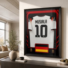 Frameworth Official FIFA World Cup 2026 Germany Jamal Musiala Framed Replica Jersey - 25.75" x 33.75"-Professionally framed in Canada, with the replica jersey mounted in a premium black frame and a clear protective front.
