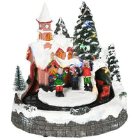 HOMCOM Christmas Village Houses with Rotating Train and LED Lights-Features 1 church, 5 Christmas trees, 1 square, 2 musicians on the bench, 1 commander and 1 moving train on a rotating track 