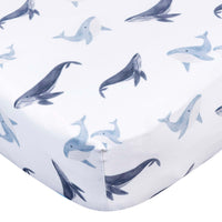 Gerber Childrenswear Knit Crib Sheet - Coastal Calm - Whales-Crafted from a durable blend of polyester and stretchy spandex jersey, this sheet ensures a snug fit on standard crib mattresses, measuring 52 x 28
