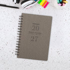 AT-A-GLANCE 2027 Signature Small Weekly/Monthly - 8-½" H x 6" W - Gray Cover - Bilingual-Monthly: Open writing blocks, one month per two-page spread