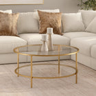 Hudson&Canal Sivil 36"W Round Coffee Table with Glass Top - Brass-Top has a weight capacity of 50 lbs, shelf can hold 40 lbs