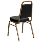 Flash Furniture HERCULES Series Trapezoidal Back Stacking Banquet Chairs with Black Vinyl & Gold Frame - 4 Pack-Black Vinyl Upholstery