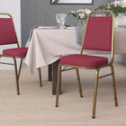 Flash Furniture HERCULES Series Trapezoidal Back Stacking Banquet Chair in Burgundy Patterned Fabric - Gold Frame-Seamless Back Panel