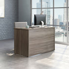 Sauder 47"W Affirm Desk - Hudson Elm- Cord management system with two desk top grommet holes to keep your desk clutter free