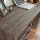 Sauder 60"W Aspen Post Desk - Pebble Pine-Storage area behind door features an adjustable shelf and holds vertical CPU tower.